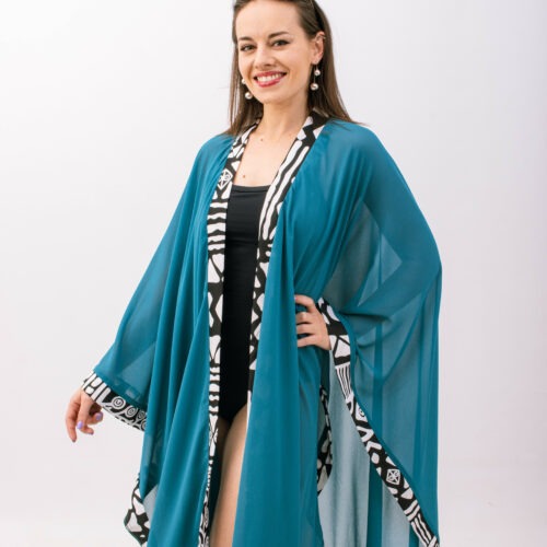 This teal kimono is the perfect piece for any occasion. Wear it over a swimsuit, or dress it up with jeans and a tank top for a night out. The lightweight fabric is perfect for layering, and the vibrant color, simply captivating