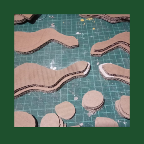 Image shows cardboard cutouts of leg pieces.