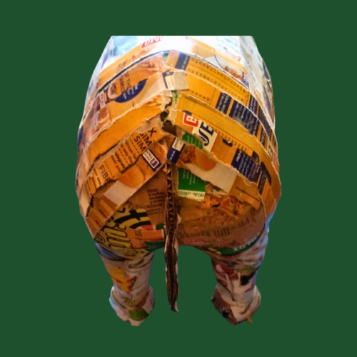 Image shows the rear end of a rhino made from upcycled materials, covered with strips of cereal boxes.