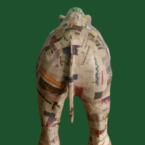 Image shows the rear end of an upcycled rhino work in progress, covered with a layer of newspaper strips.