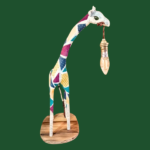 Image of a lamp sculpted in the form of a giraffe, from upcycled materials including dictionary pages and fabric.