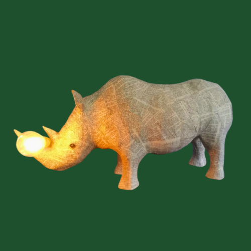 Lamp sculpted in the shape of a rhino, from upcycled materials including dictionary pages.