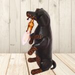Image of a sculpted dark brown dachshund lamp made of upcycled materials including yellow and brown shweshwe.